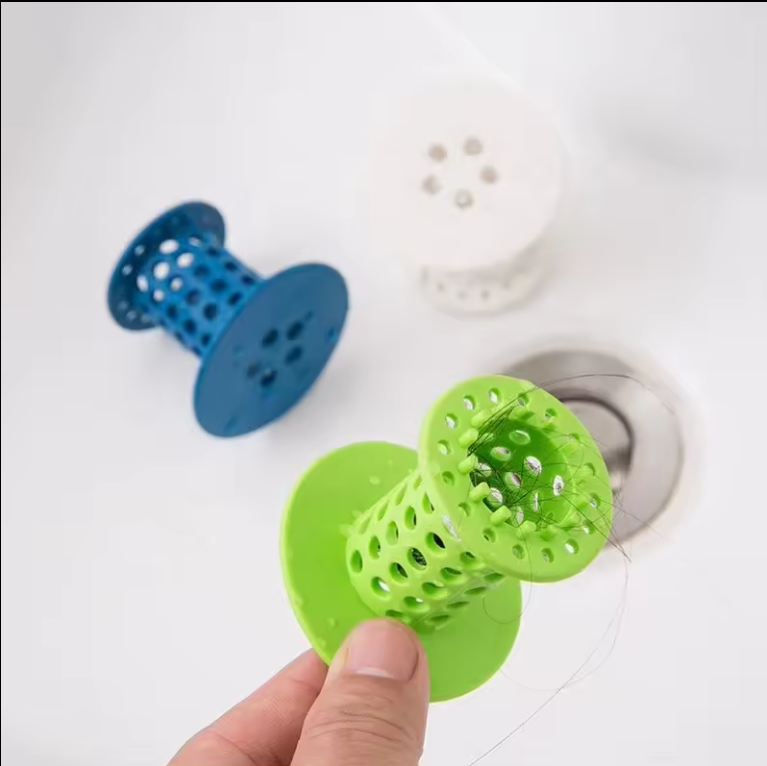 Hair catchers next to a bathtub drain