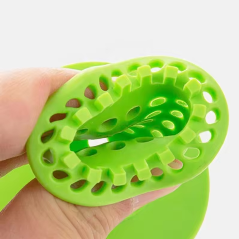 Green drain hair catcher in hand