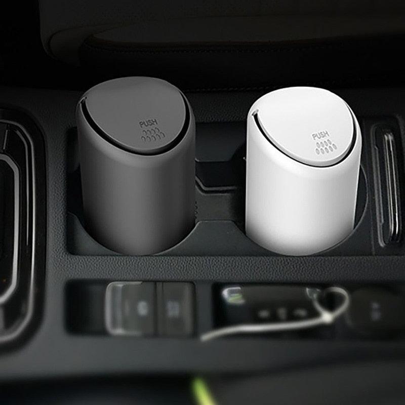 ProClean mini car trash cans in black and white sitting in a car cup holder